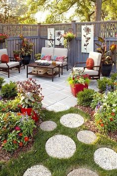 an outdoor patio with lots of flowers and potted plants