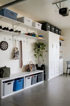 a room filled with lots of white shelves and bins on top of it's walls