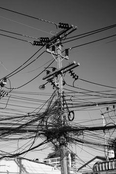 black and white photograph of power lines and telephone poles