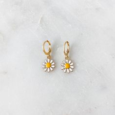 Dainty mini hoop earrings featuring a white daisy charm ❀❀ INFO: ❀❀ ➳ Hoop size: 12.5 mm x 14.5 mm ➳ Daisy charm size: 11 mm ➳ Hoops are gold plated stainless steel ➳ Daisy charm is gold plated brass ❀❀ PURPLE & GREEN DAISY EARRINGS: ❀❀ https://www.etsy.com/listing/1063301184/mini-daisy-hoop-earrings-in-lilac-purple?ref=shop_home_active_1 ❀❀ VIEW MORE EARRINGS: ❀❀ https://www.etsy.com/shop/bitsnpiecess/?section_id=23539584 ❀❀ SHIPPING & PROCESSING: ❀❀ Please refer to my shop announcement Spring Hoop Earrings With Flower Charm As Gift, Spring Flower Charm Hoop Earrings As Gift, Trendy Hoop Earrings With Flower Charm For Spring, Spring Gift Hoop Earrings With Flower Charm, Small Hoop Jewelry For Spring Gift, Spring Gift Jewelry: Small Hoop, Everyday Flower Charm Hoop Earrings, Trendy Small Hoop White Jewelry, Nickel-free White Huggie Earrings