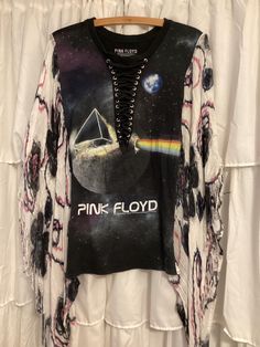 Pink Floyd t-shirt has been modified into a poncho using a floral print cotton scarf. One of a kind, ones size fits most. Spring Long-sleeved Cotton Poncho, Spring Cotton Poncho, Spring Long Sleeve Cotton Poncho, Bohemian Style T-shirt For Fall Festival, Bohemian Fall Festival T-shirt, One Size Festival Tops For Fall, Bohemian Cotton Tops With Unique Print, Bohemian Cotton Tops With Batwing Sleeves, Bohemian Cotton Top With Unique Print