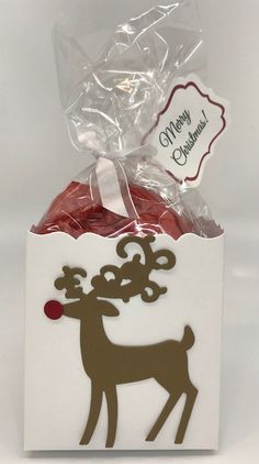 a white box filled with candy and a reindeer sticker on the top of it