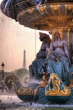 a fountain with two women sitting on it