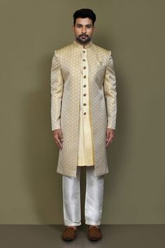 Gold and yellow full sleeves layered sherwani crafted in jacquard silk with prism helix pattern detailing on the outer layer and plain front button detail inner layer. Paired with a cream Aligadhi pant. - Aza Fashions Yellow Sherwani With Cutdana In Straight Kurta Style, Yellow Sherwani With Zari Work And Traditional Drape, Yellow Kurta With Naqshi For Wedding, Gold Raw Silk Sherwani With Cutdana, Yellow Naqshi Kurta For Wedding, Yellow Bandhgala With Zari Work In Traditional Drape, Yellow Traditional Drape Sherwani, Gold Raw Silk Bandhgala With Cutdana Detailing, Gold Raw Silk Bandhgala With Cutdana