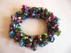 a multicolored christmas wreath with bells on it