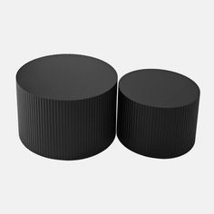 two black round tables sitting next to each other