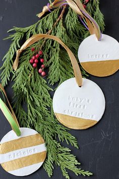 three handmade christmas ornaments hanging from a tree