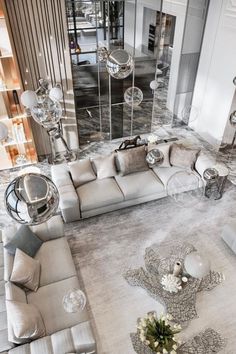 a living room filled with furniture and mirrors