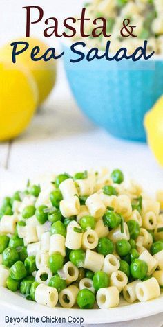 pasta and pea salad on a plate with lemons in the background