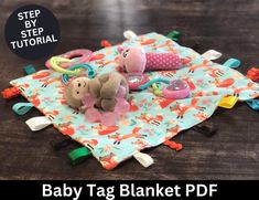 a baby tag blanket with stuffed animals on it