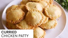 a white plate topped with small pies on top of a table next to broccoli