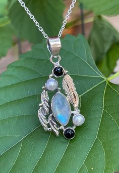 "Handmade, vintage, one-of-a-kind, fit for a goddess or a god, artisan piece, natural rainbow moonstone +natural pearls +natural black onyx, pendant necklace set in 925 sterling silver. 18 inches long 925 sterling silver chain. Pendant dimensions: 1.50\"(1.90\" including bail) X 0.90\"" Handmade Black Moonstone Jewelry, Elegant Black Moonstone Jewelry, Black Moonstone Necklace For Gift, Mystical Healing Necklace With Cabochon, Spiritual Black Moonstone Jewelry, Bohemian Black Moonstone Jewelry, Black Moonstone Spiritual Jewelry, Silver Moonstone Moon-shaped Crystal Necklaces, Luxury Moonstone Cabochon Necklace