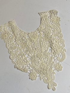 a piece of white lace sitting on top of a table