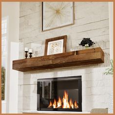 a fire place in the middle of a living room with pictures on the wall above it