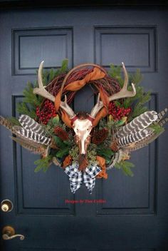 a deer skull with antlers and wreath on the front door