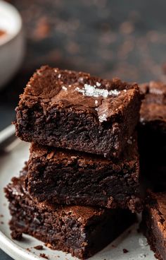 chocolate brownies stacked on top of each other with one bite taken out of it