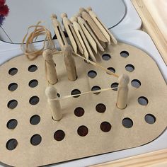 wooden pegs are arranged on top of a board