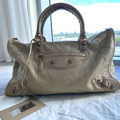 For Sale $2200 Current Retail Price For A Large Le City On Balenciaga Website: $3,250 Brand: Balenciaga Le City Large Colour: Beige Material: Leather Includes Balenciaga Dustbag This Bag On Offer Is A Beautiful, Versatile Beige Bag, In A Large Size. It Was Worn Twice And Then Stored In Its Balenciaga Dustbag It Is In Perfect Condition Exterior: Beautiful, Rare Rose Gold Grommet Hardware, Undamaged, No Scratches Or Scuff Marks The Handles Are In Perfect Condition And The Braiding Is Perfect , Unw Designer Beige Bags With Branded Hardware, Designer Beige Bags For Everyday Luxury, Designer Beige Satchel, Beige Bags With Branded Hardware For Everyday Luxury, Designer Beige Satchel With Branded Hardware, Beige Handbag, Bags Balenciaga, Rare Roses, Beige Handbags