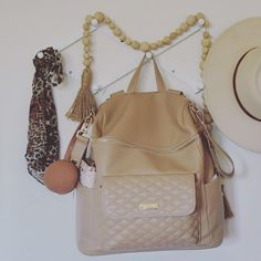 a purse, hat, and other items are hanging on the wall