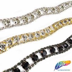 three different colored chains with black, white and yellow stones in them on a white background