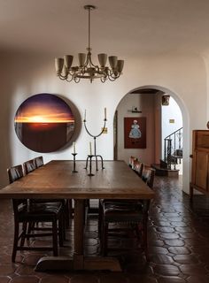 a dining room with a large wooden table and chairs