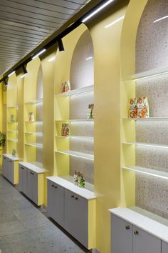 a row of shelves with yellow and white walls