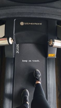 a person standing on top of a treadmill with their feet propped against the machine