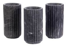 three black vases sitting next to each other