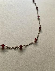 This gorgeous choker necklace features garnet crystal bicone beads on a sterling silver chain. It is 15.5" long. Silver Choker With Faceted Beads For Gift, Garnet Crystal, Beaded Choker Necklace, Choker Necklaces, Beaded Choker, Sterling Silver Chain, Crystals And Gemstones, Sterling Silber, Sterling Silver Chains