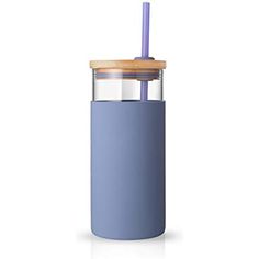 a blue tumbler with a wooden lid and straw sticking out of the top, on a white background