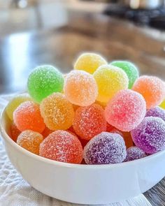 a bowl filled with gummy bears sitting on top of a table