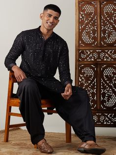 Vastramay Men's Black Mirror Georgette Kurta With Patiala Set Make a statement in this elegant black kurta with a stylish mirror work design. The georgette fabric adds a touch of luxury, perfect for festive occasions or special events. Features: Black georgette kurta with mirror work Patiala set for a complete traditional look Comfortable and stylish Specifications: Brand: VASTRAMAY Color: Black Fabric: Georgette Neck: Mandarin Collar Sleeve Length: Full Sleeves Material & Care: Georgette, Dry-c Black Semi-stitched Long Sleeve Bandhgala, Transitional Black Sherwani For Party, Transitional Party Sherwani In Black, Black Semi-stitched Bandhgala For Festive Occasions, Festive Semi-stitched Black Bandhgala, Black Straight Kurta For Party, Black Kurta For Party, Black Sherwani With Mirror Work For Party, Party Black Sherwani With Mirror Work