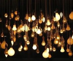 black and white photograph of chandeliers hanging from the ceiling in a dark room