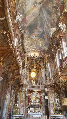 the interior of an old church with paintings on the ceiling