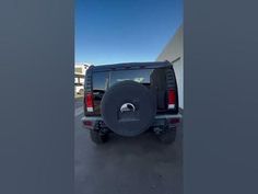 the back end of a vehicle parked in a parking lot with no one around it