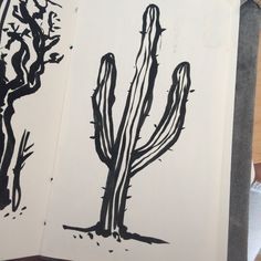 an ink drawing of a cactus next to a tree and another plant on a piece of paper