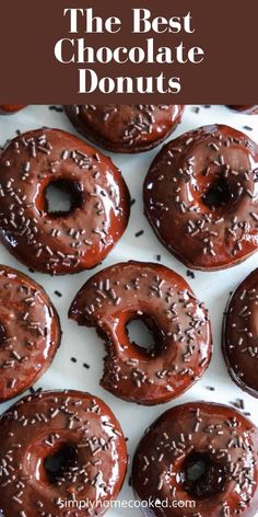 chocolate donuts with sprinkles are on a white tray and the title reads, the best chocolate donuts