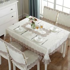 a dining room table set with place settings