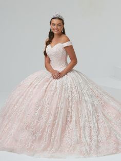 Look radiant in this long off the shoulder dress with A-line 3D floral applique skirt by House of Wu Quinceanera Collection 26983. Made out of tulle, this beautiful off shoulder ball gown features a sweetheart bodice adorned with pearl beaded 3D glitter floral appliques, cap sleeves, and gathered tulle with full layout 3D appliques A-line skirt. This look is finished with a lace-up corset back and a sweep train. House of Wu Quinceanera Collection Fall 2021 Style Number: 26983 Fabric: Tulle/Glitt Off-shoulder Tulle Dress For Quinceanera, White Off-shoulder Dress For Debutante Ball, Quinceanera Collection, Off Shoulder Ball Gown, Applique Skirt, Debutante Ball, Strapless Sweetheart Neckline, Quinceanera Dress, Quince Dresses