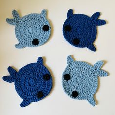 four crocheted animal heads are shown in three different colors