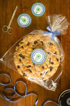 a cookie sitting on top of a wooden table next to scissors