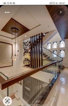 the stairs in this house are made of wood and glass, with decorative artwork on the wall