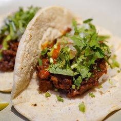 two tacos are sitting on a plate