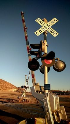 a railroad crossing sign and some traffic lights