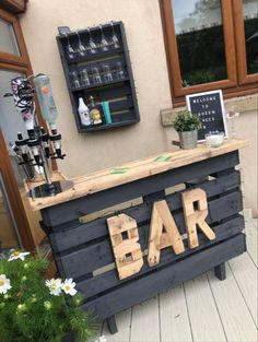 a bar made out of wooden pallets with the word bar written on it's side