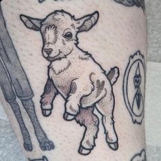 a tattoo with an image of a baby goat on it's leg and the words,