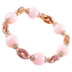 Purchased from famed jewelry designer David Morris of London, this lovely bracelet is in warm and inviting 18 karat rose gold and the pink color in the six beautifully matched opals is complimented by the bright sparkle of the 2.14 carats of pink sapphires and 3.55 carats of dazzling diamonds! The current Retail Replacement Value is $20,000 as stated by the manufacturer. Platinum Sapphire Ring, David Morris, White Gold Sapphire Ring, Gold Diamond Hoop Earrings, Pearl And Diamond Necklace, Art Deco Bracelet, White Sapphire Ring, Gold Diamond Earrings, Rose Engagement Ring