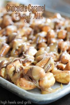 chocolate caramel pretzel nuts on a baking sheet with text overlay that reads, chocolate caramel pretzel nuts