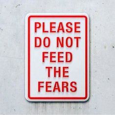 a red and white sign that says please do not feed the fears on it