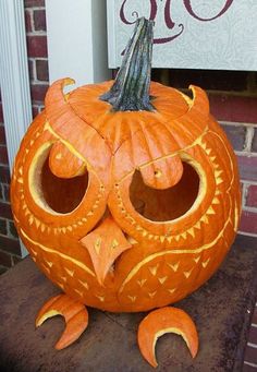 a carved pumpkin with an owl face on it